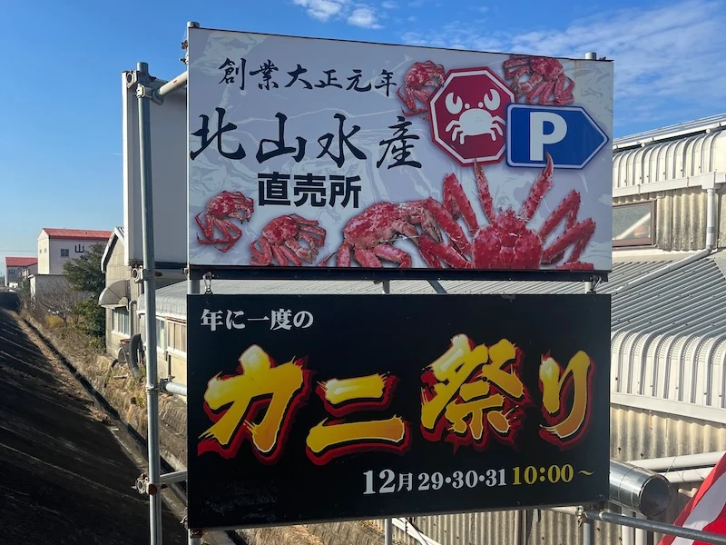 駐車場の看板とカニ祭りの看板