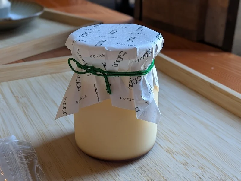 ロゴ入りの紙で包まれたGOTANGの瓶プリン